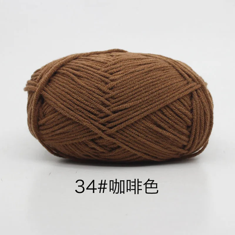A ball of brown 4-ply milk cotton yarn for knitting and crochet.