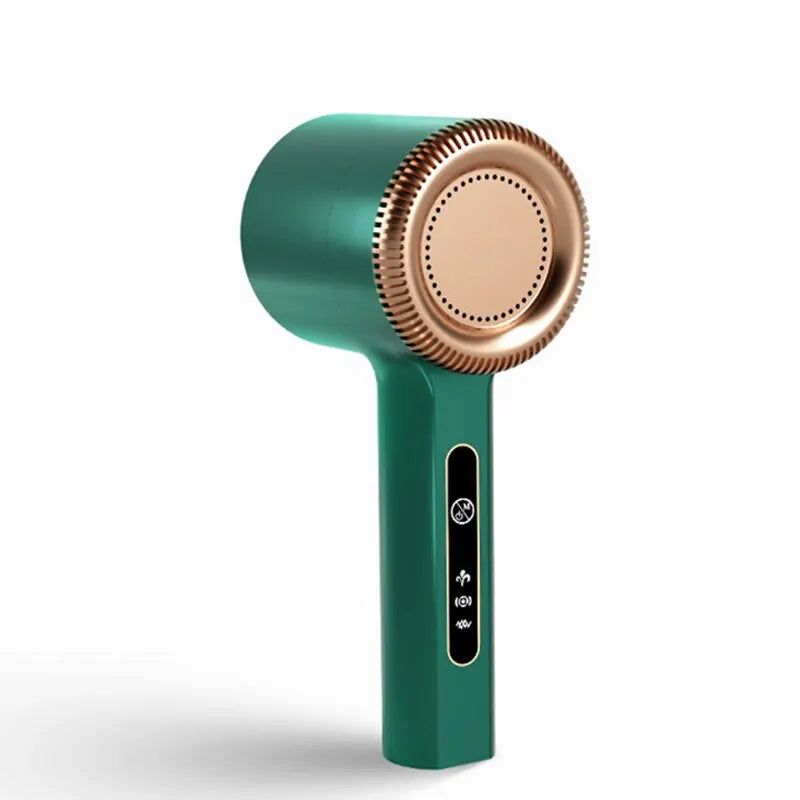 A teal electric lint remover with a brass-colored rotating head and a black power button.
