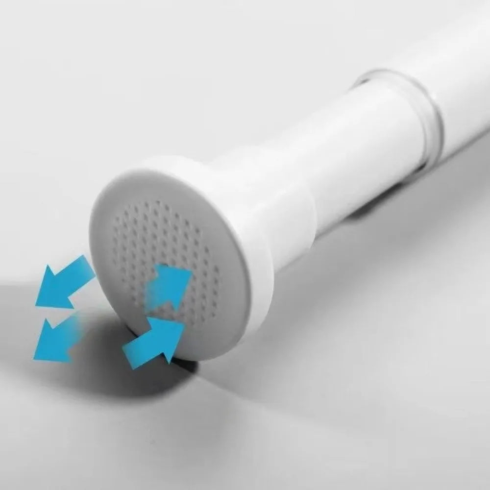 A close-up view of a white no-drill adjustable steel tension curtain rod with hanging clips.
