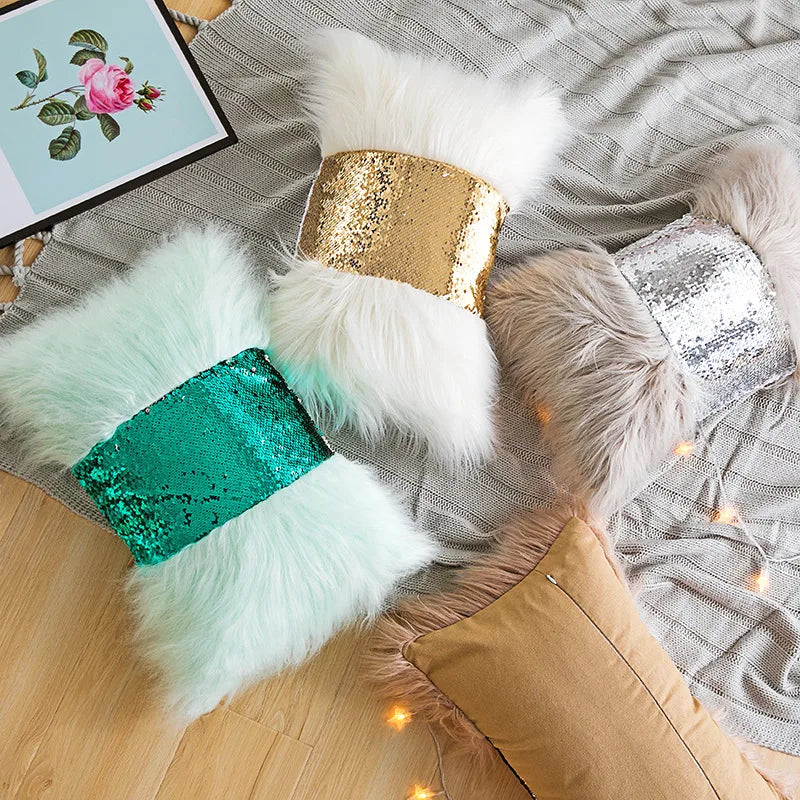 Decorative pillow covers featuring silver and gold sequins on white fur cushions.