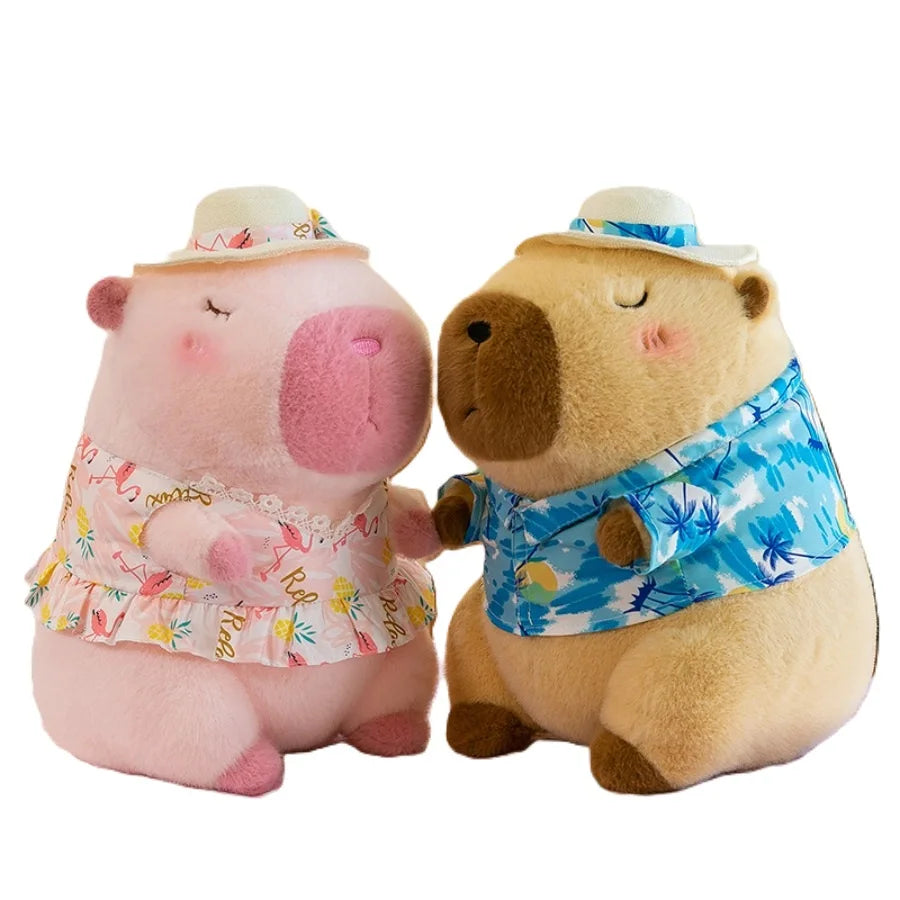 A pink capybara plush toy wearing a straw hat and a blue patterned swim top.