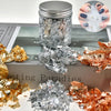 Jar of metallic foil flakes in gold, silver, and copper colors for crafting projects