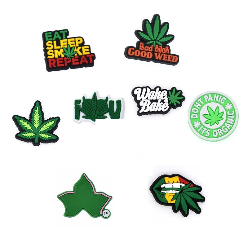 A set of green PVC pins featuring cannabis leaf designs and text like Eat Sleep Smoke Repeat and Bad Birch Good Weed