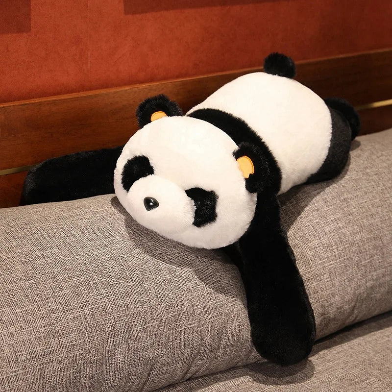 A giant soft panda plush toy with long arms resting on a gray sofa.