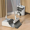 A white 3-in-1 folding broom and dustpan set with an aluminum handle resting on a wooden floor.