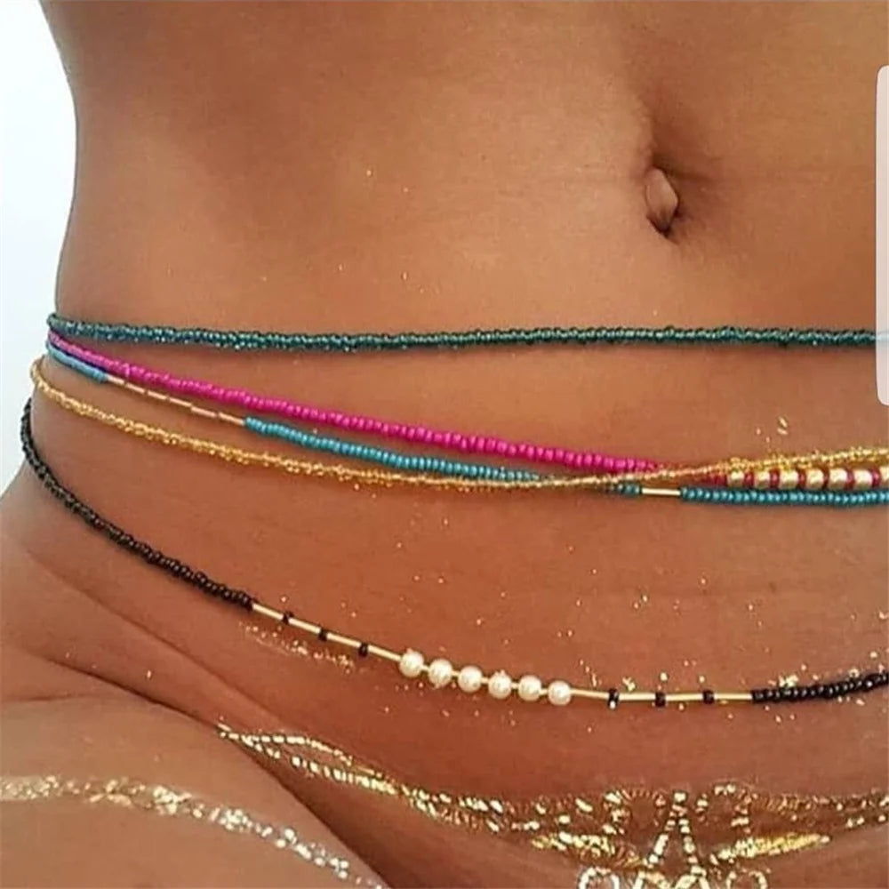 Colorful beaded elastic waist chains worn around the midsection of a woman's torso.