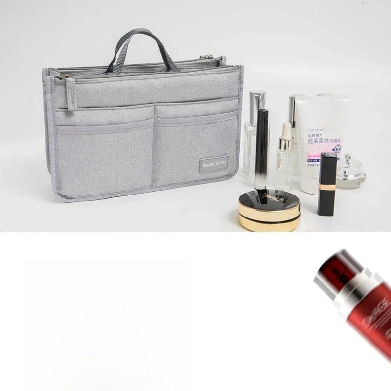 A silver purse organizer insert with multiple compartments and a handle, shown next to various cosmetic products.