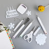 A set of six white vinyl weeding and craft tools, including a spatula, needle, and scissors, arranged on a gray surface.