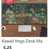 A desk mat featuring a nature design of frogs and plants, displayed next to a computer setup.