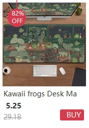 A desk mat featuring a nature design of frogs and plants, displayed next to a computer setup.