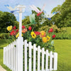 White picket fence display featuring lifelike dragonfly garden clips with insect repellent designs.