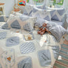 A set of light pink and gray patterned cotton duvet covers and pillow shams with happy little friends designs.