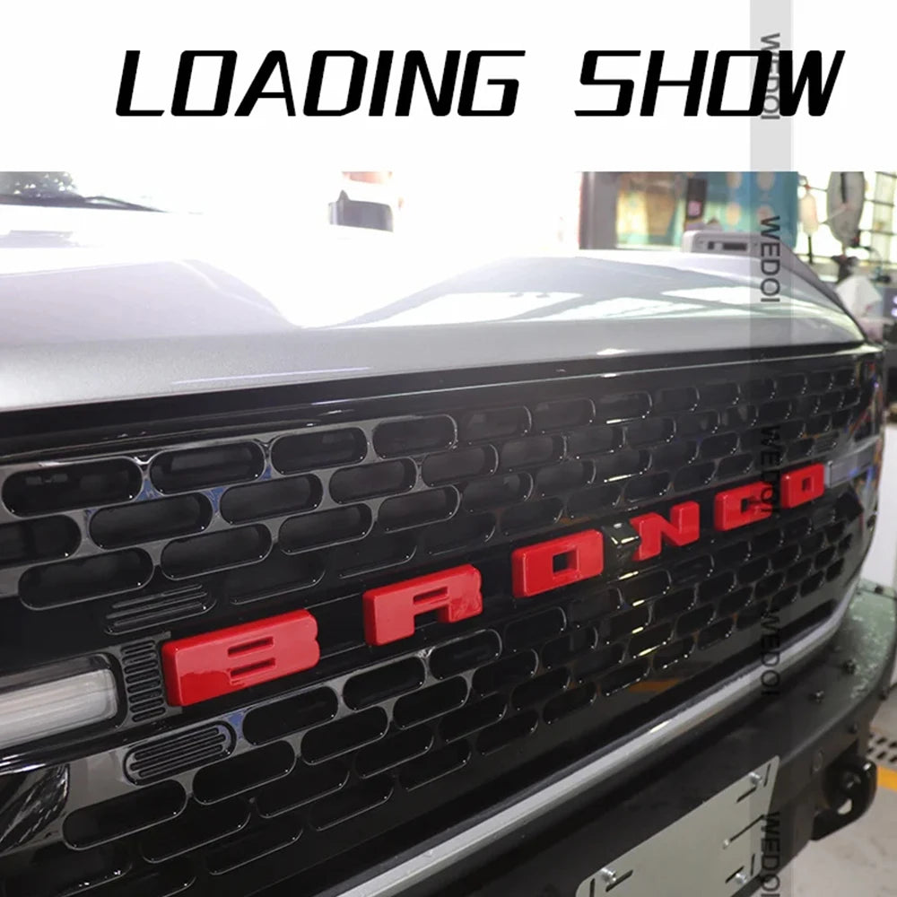 Close-up of a black Ford Bronco grille with red 3D ABS emblem letter covers.