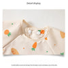 A light beige children's feeding bib with a round neck design and an orange carrot motif.