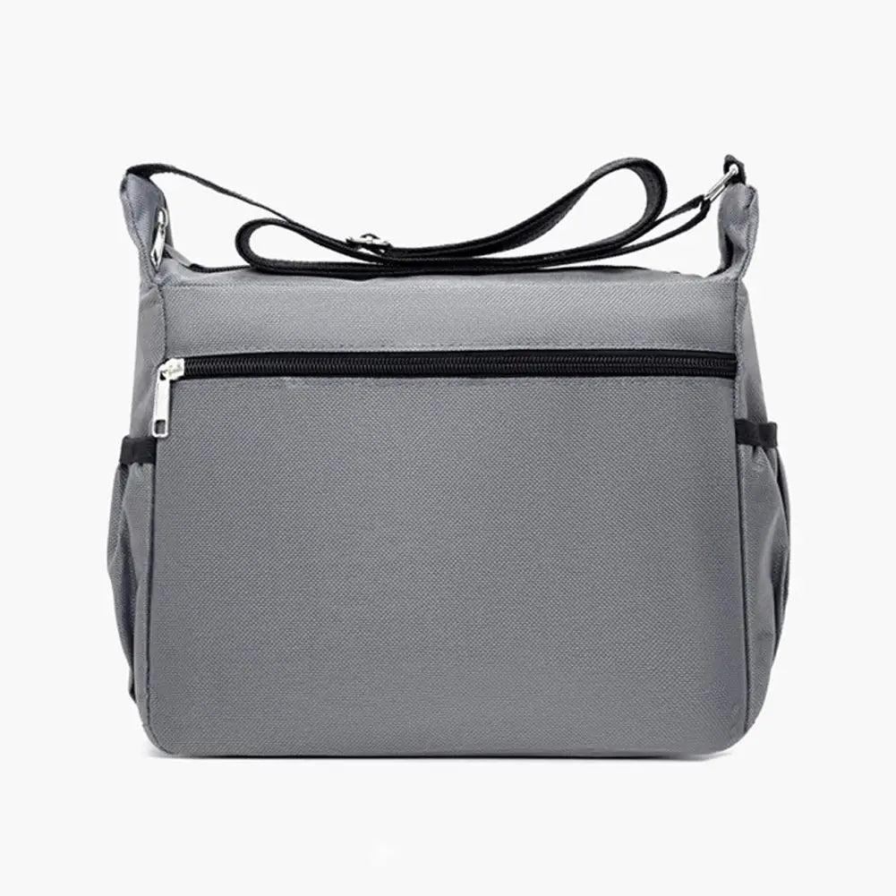 A gray men's waterproof crossbody bag with a zippered pocket and adjustable strap.