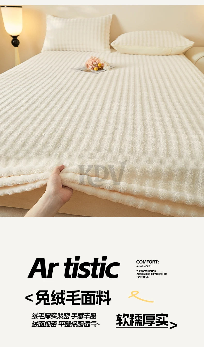A close-up of a cream colored faux fur fitted sheet being touched on a bed.