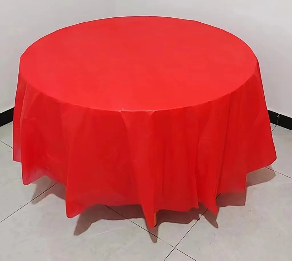 A vibrant red disposable round tablecloth is displayed on a table.