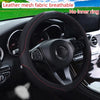 Black leather mesh fabric steering wheel cover with red stitching and diamond accents shown in a car interior.