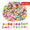 A large pile of assorted polymer clay beads featuring summer fruit designs in various colors and shapes.