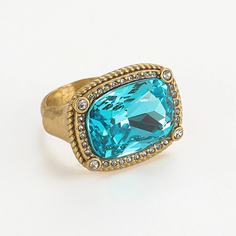 Vintage sea blue crystal cocktail ring featuring a large, faceted blue gemstone set in gold-toned metal.
