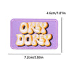 Purple embroidered iron-on patch featuring the words OKAY DOKEY in orange and yellow thread.