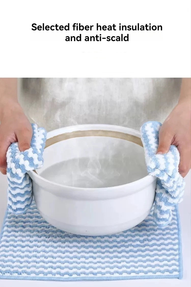 Blue microfiber cleaning cloths being used to insulate and protect a white bowl from hot liquid.