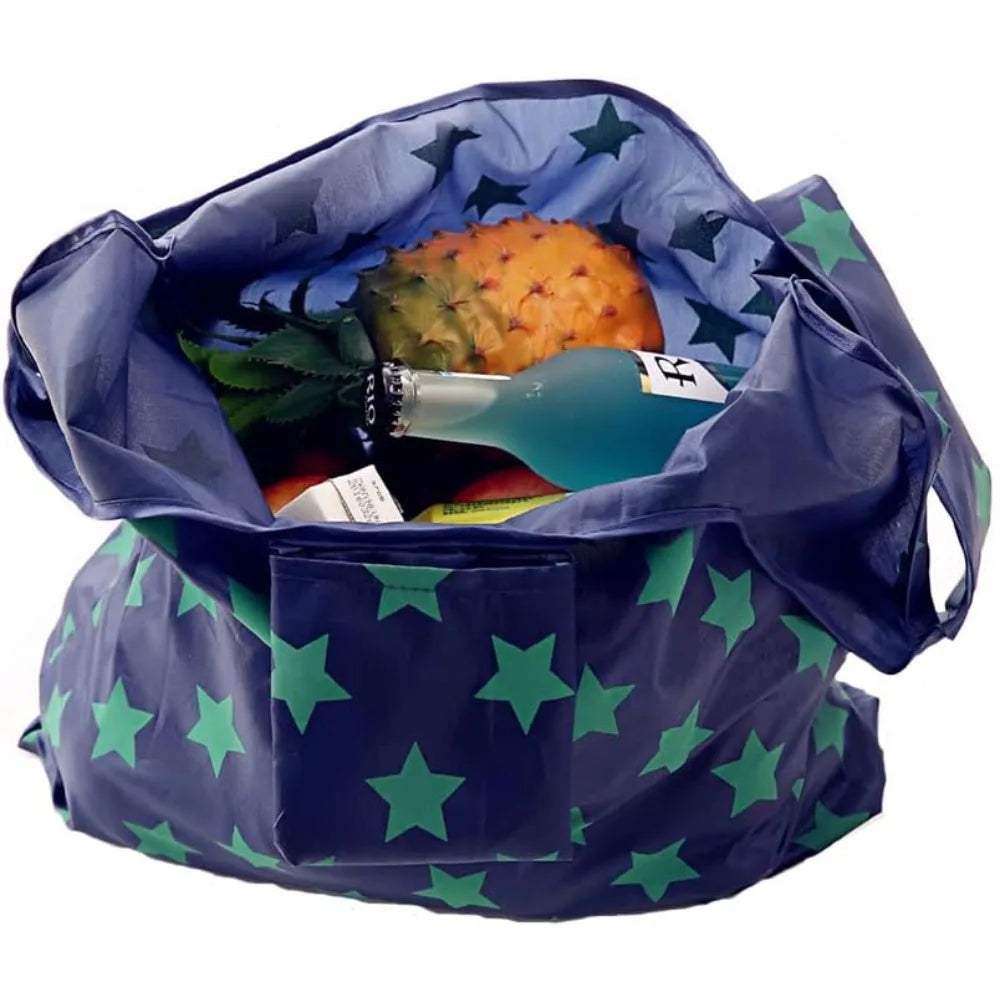A dark blue foldable tote bag filled with a piece of fruit and green leaves.
