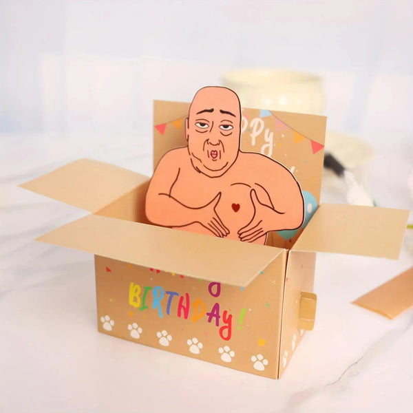 A humorous 3D pop-up birthday card featuring a surprised-looking character inside a cardboard box.