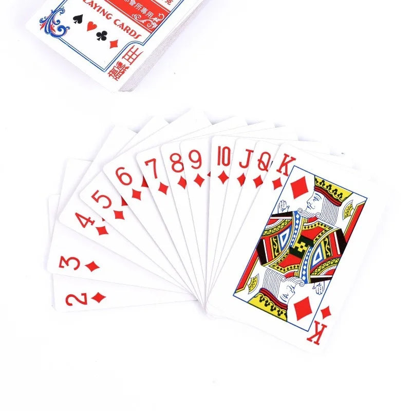 A stack of red playing cards, including aces and kings, is shown next to a deck box.