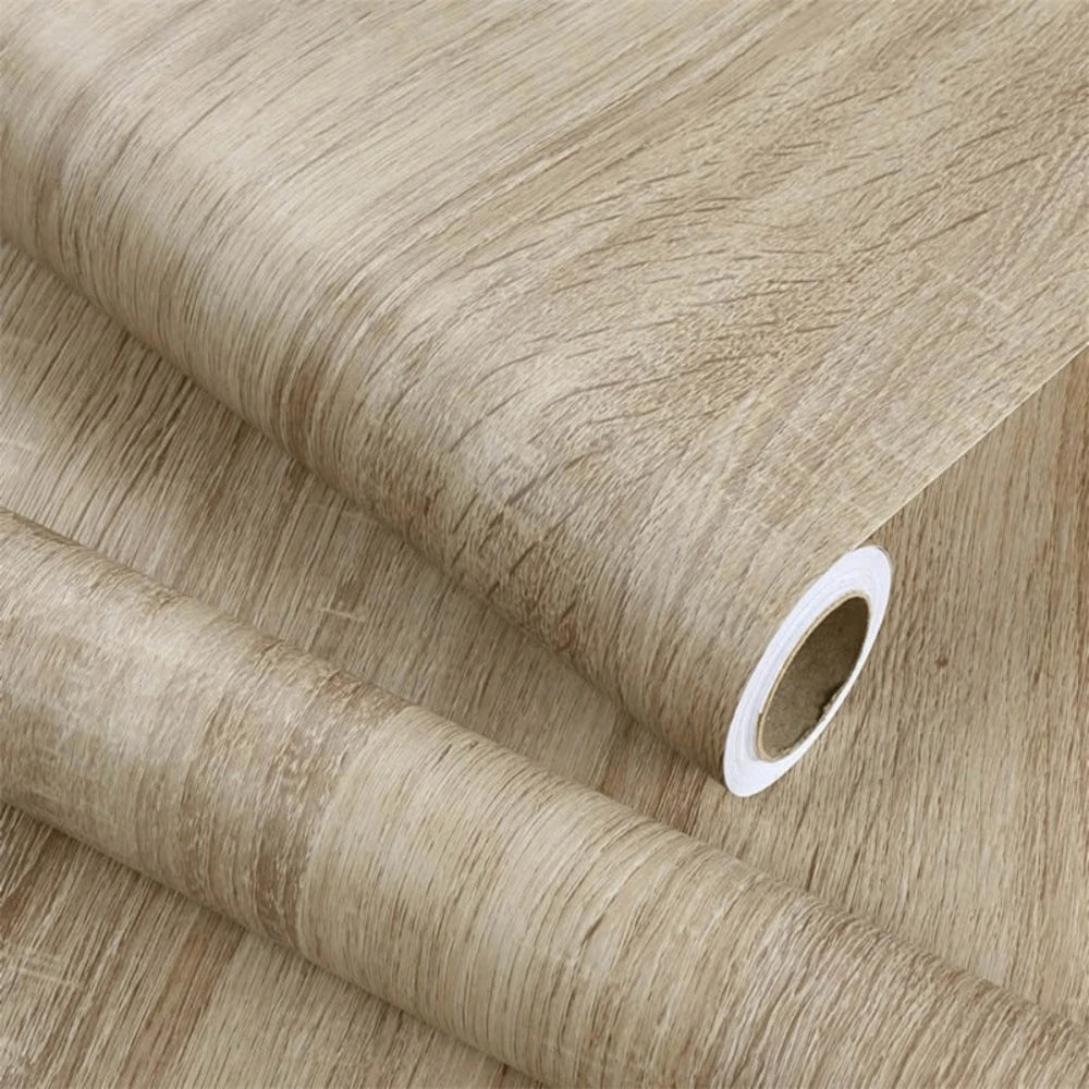 Roll of self-adhesive wood grain wallpaper film in a natural beige tone.