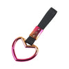 Heart-shaped car handle decor with a holographic finish and black strap.