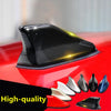 Black universal car shark fin antenna cover displayed on a red car surface with various fin shapes.