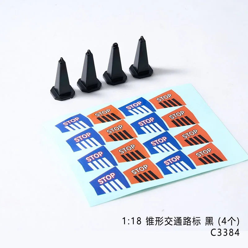 A set of four black traffic cones and a sign with stop markings for an RC car decorative accessory kit
