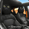 Two black cat headrest covers with yellow eyes are shown inside a car cabin.
