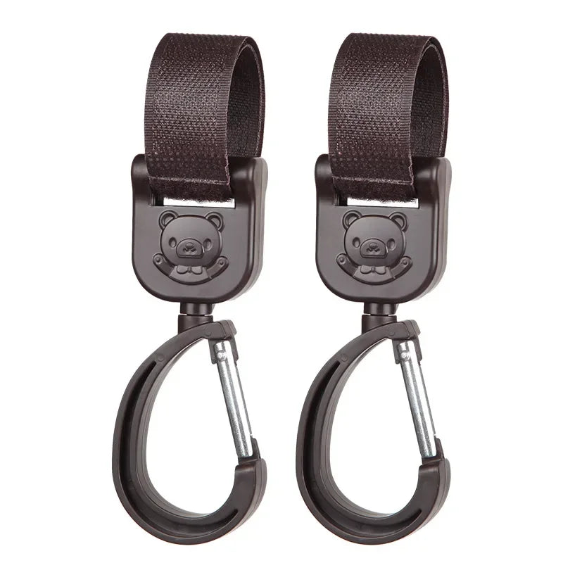 A pair of dark brown 360° rotating stroller hooks for hanging bags and essentials.