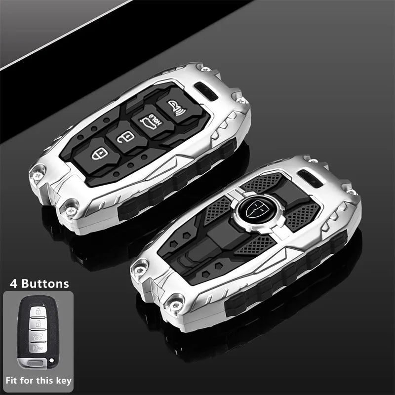 Silver protective key fob cover with four buttons shown on a dark surface.