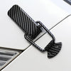 Black carbon fiber rear trunk locking buckle set mounted on a white car panel.
