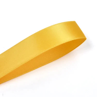 A roll of bright yellow double face satin ribbon.