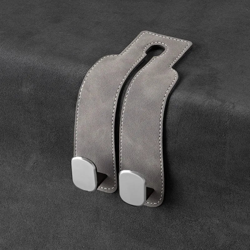 Dual suede hooks for handbags and other items, designed to attach to a car seat back.