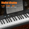 A digital display piano showing musical notation and keys, with a keyboard visible below.