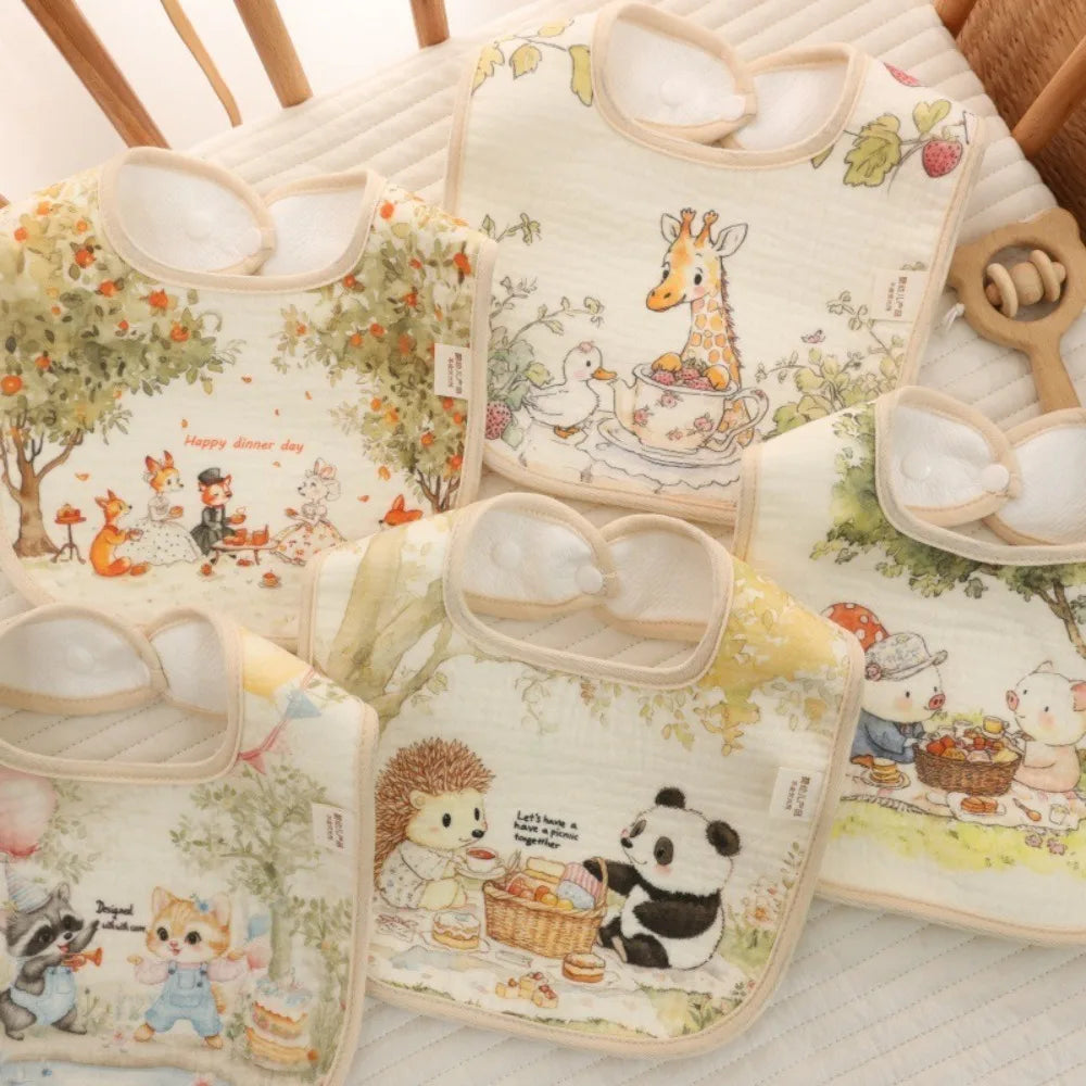 A collection of soft cotton waterproof baby bibs featuring cute animal illustrations and adjustable neck straps.