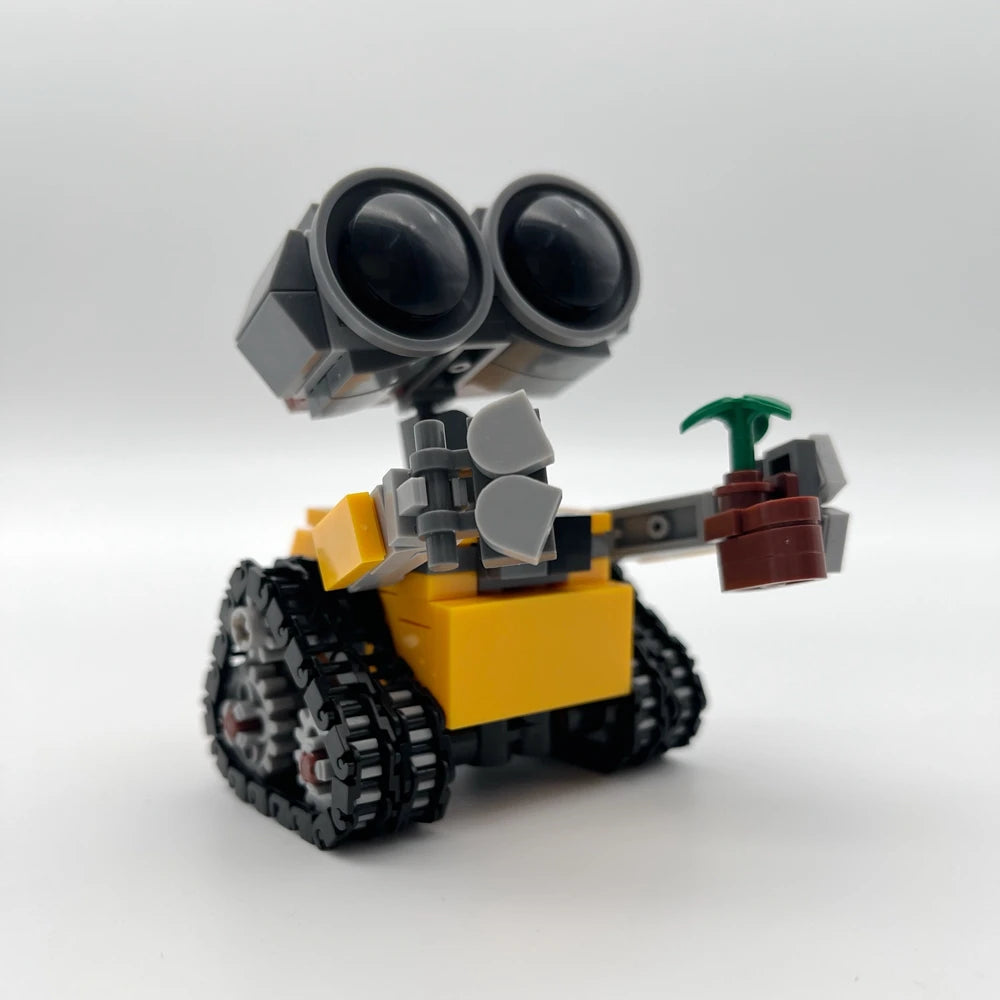 Set de bloques de construcción mini robot amarillo y gris con ojos grandes y antena verde.