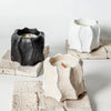 Three textured concrete candle holders made from silicone molds, featuring wavy edges and natural plaster finishes.