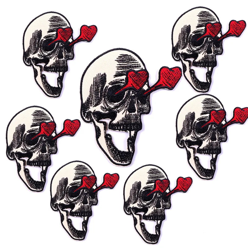 A set of ten embroidered iron-on patches depicting skulls with red tongues.
