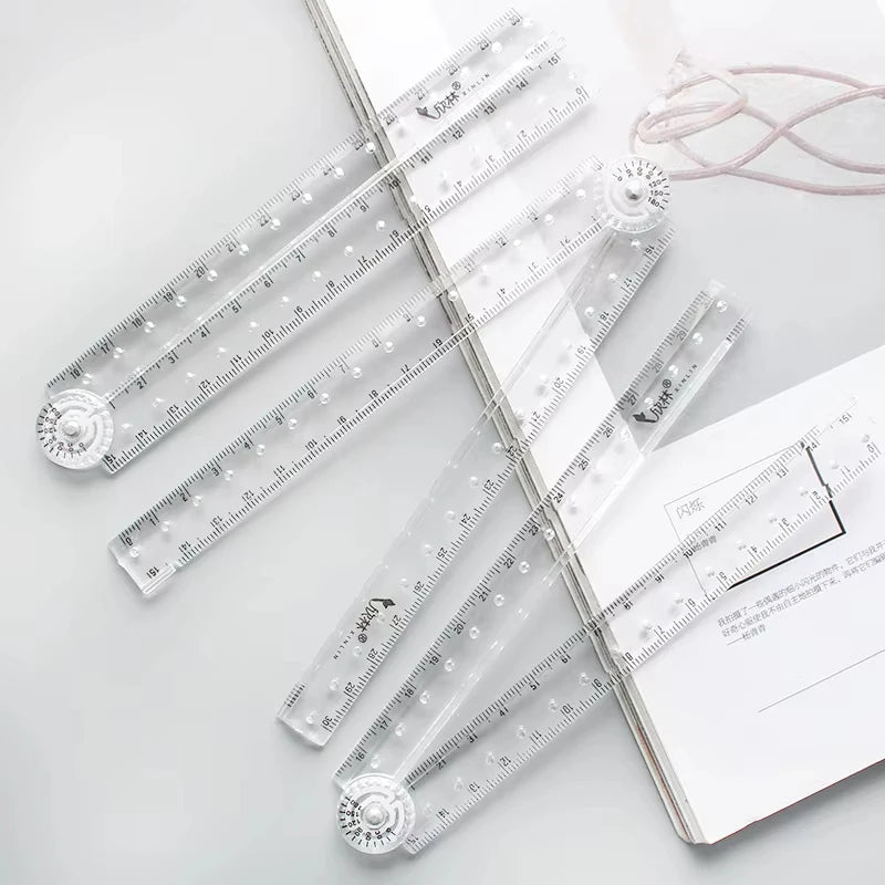 Transparent foldable plastic rulers for students displayed on a white background.