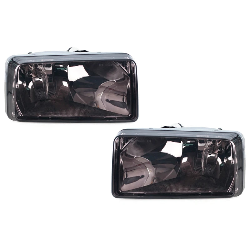 A pair of clear black direct-fit fog light assemblies for Chevy Silverado, Tahoe, Suburban, and Avalanche.