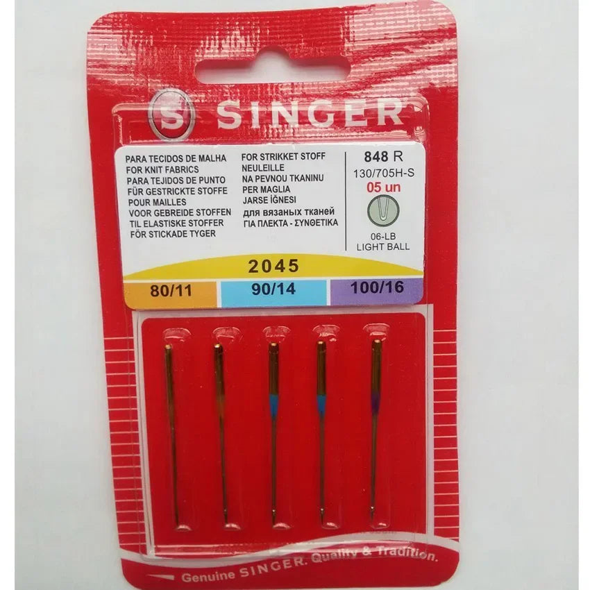 A red plastic package containing a set of Singer ball point sewing machine needles.