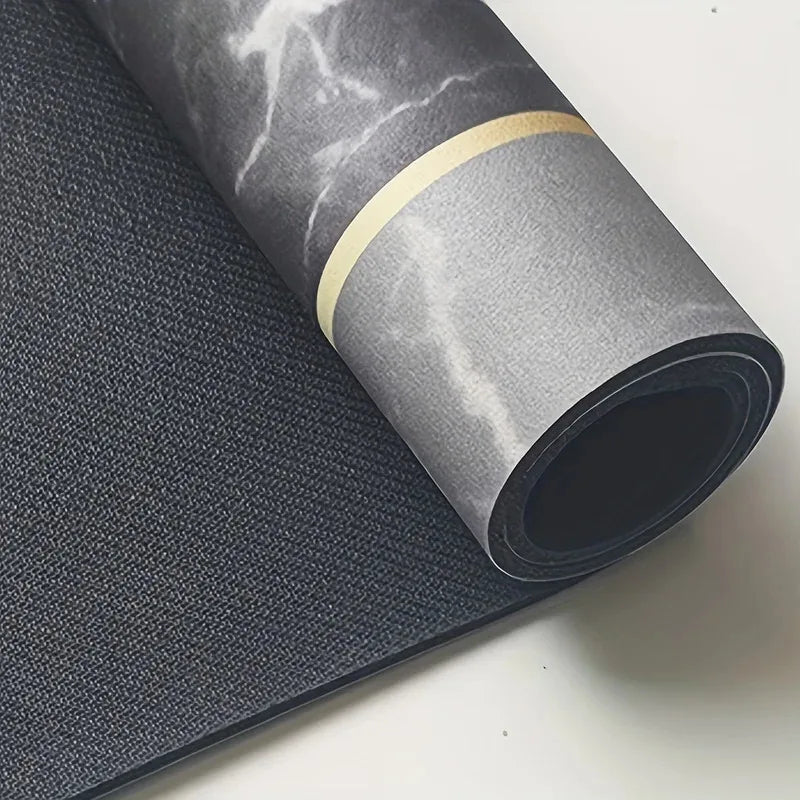 Roll of dark gray diatomite bath mat with a gold accent ring