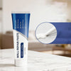 A tube of Wall Repair Paste Kit with scraper and sandpaper for drywall fixes is shown on a white marble surface.