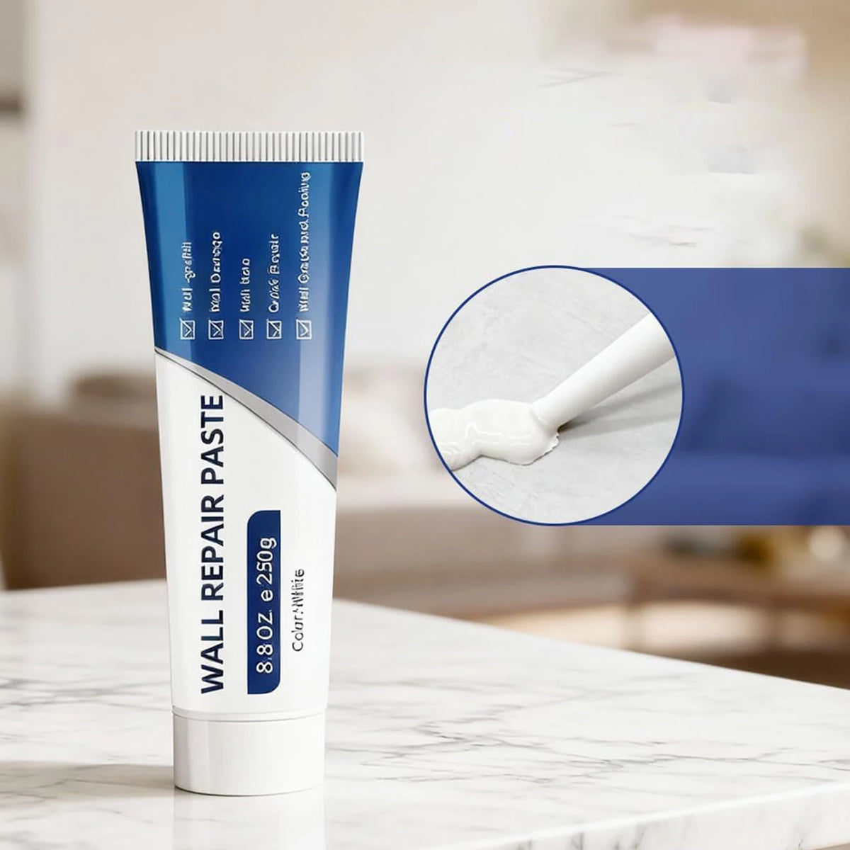 A tube of Wall Repair Paste Kit with scraper and sandpaper for drywall fixes is shown on a white marble surface.
